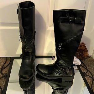 Woman’s black leather tall boots with zipper details